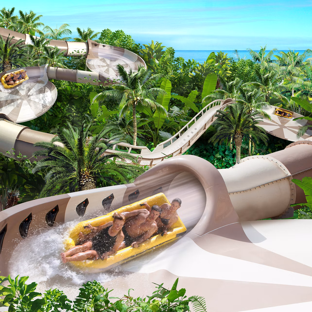 People riding a large water slide through lush tropical greenery with loops and turns, ending in a splash.