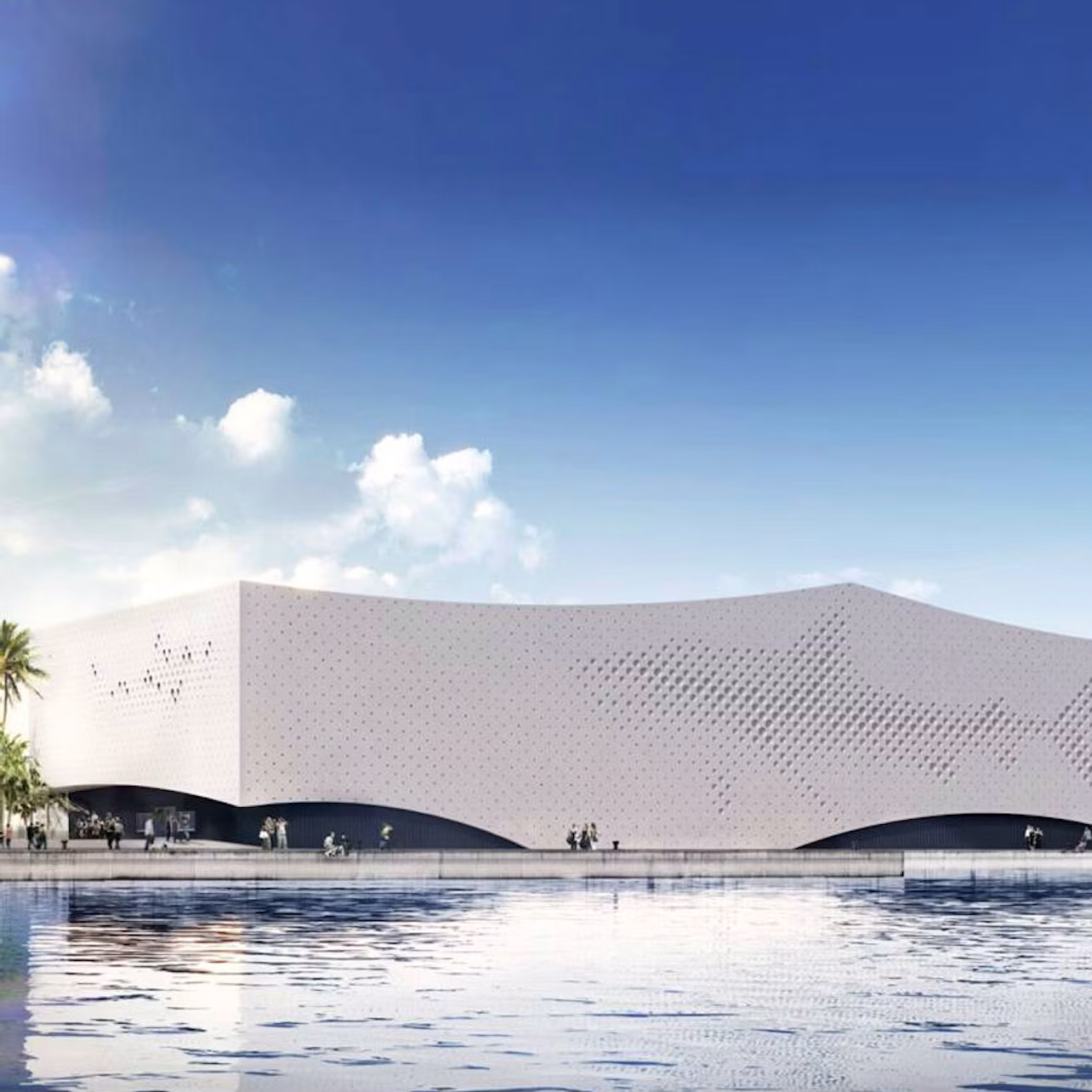 Modern white building with perforated design, reflecting in a calm water surface, under a blue sky with scattered clouds.