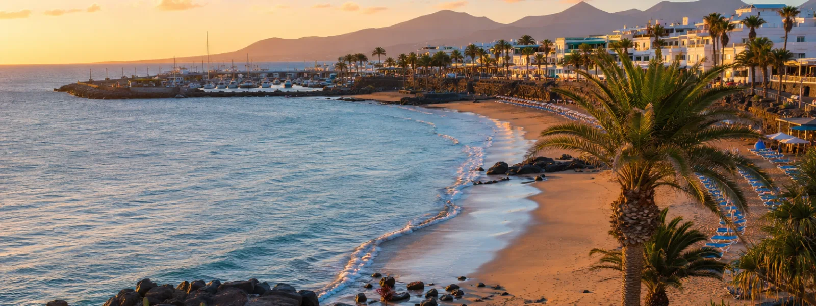 Golden-hour view of Puerto del Carmen coastline in Lanzarote for couples choosing where to stay