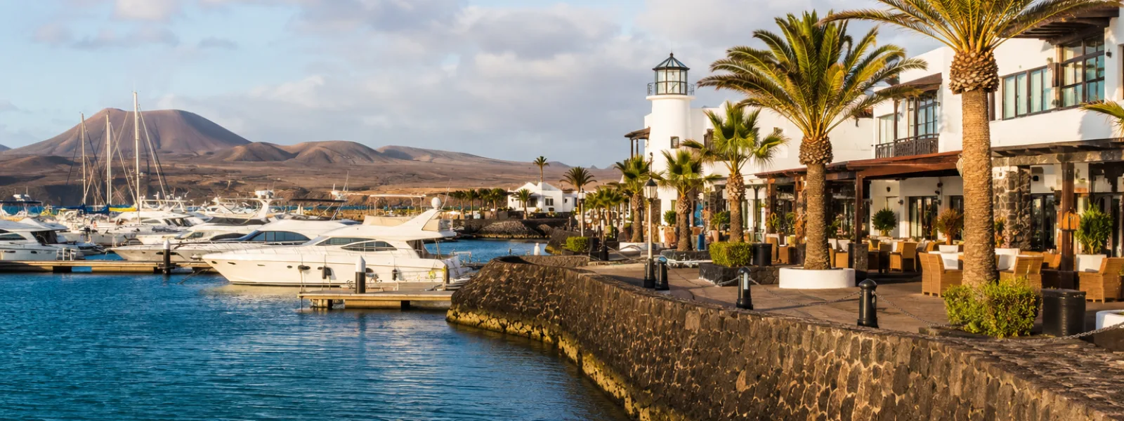 Marina Rubicon waterfront in Playa Blanca, Lanzarote with yachts and resort promenade