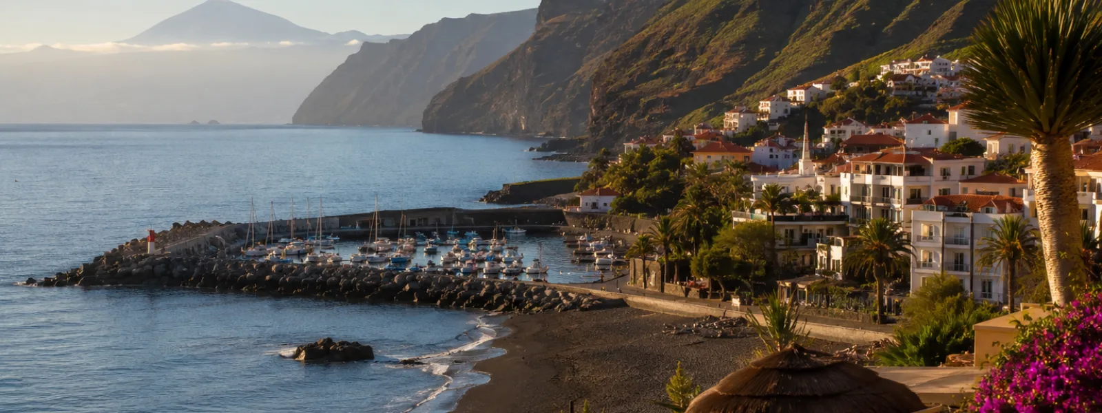 Playa de Santiago in La Gomera with volcanic beach, marina and south coast hotel scenery