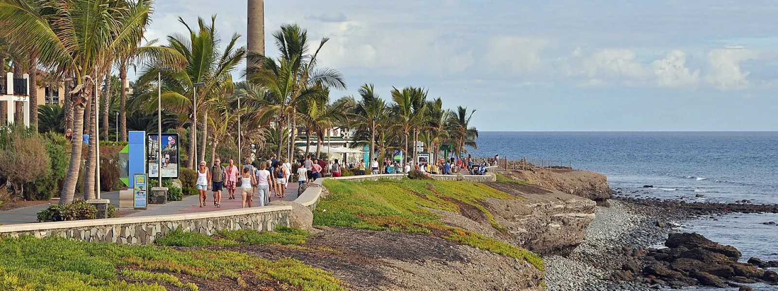 Palm-lined Meloneras promenade and Maspalomas lighthouse, southern Gran Canaria