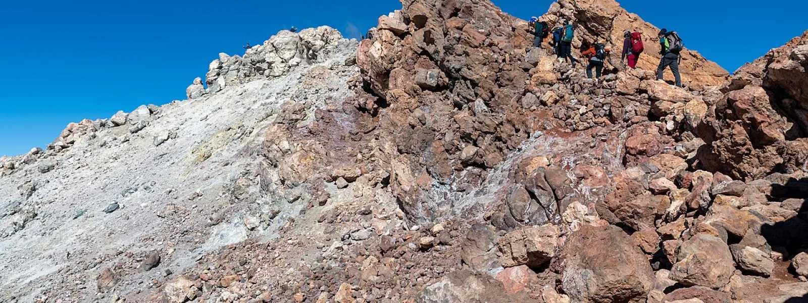 Hikers approaching the summit of Mount Teide via the steep final Telesforo Bravo trail, Tenerife