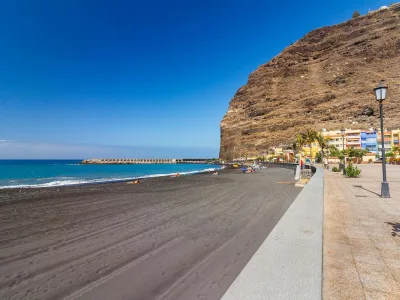 Spiaggia a La Palma con sabbia nera, lungomare e scogliere vulcaniche