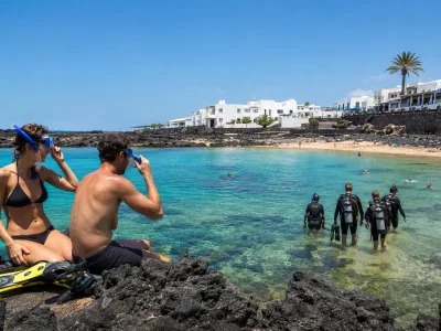 Snorkellers and scuba divers at Playa Chica in Puerto del Carmen, Lanzarote