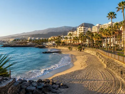 Walkable beach resort area in south Tenerife with hotels, promenade and calm Atlantic water