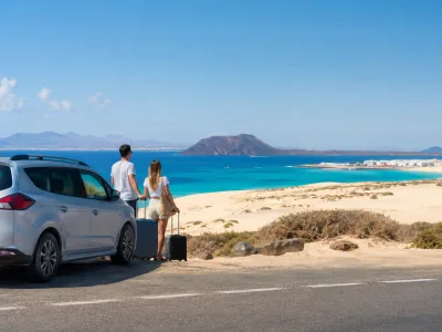 Travelers arriving near Corralejo dunes after a Fuerteventura Airport transfer