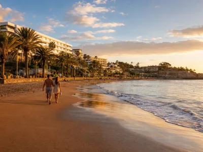 San Agustin beach in Gran Canaria with quiet resort hotels and a seafront promenade