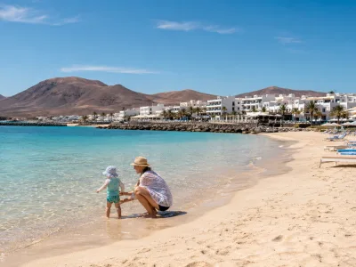 Family-friendly Playa Flamingo beach in Playa Blanca, Lanzarote with calm shallow water and resort hotels nearby