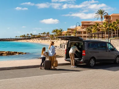 Airport transfer vehicle arriving near hotels and El Castillo beach in Caleta de Fuste, Fuerteventura