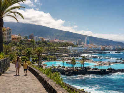 Family walking beside the Lago Martianez promenade in Puerto de la Cruz, Tenerife