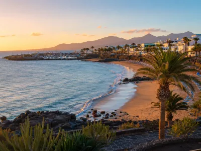 Golden-hour view of Puerto del Carmen coastline in Lanzarote for couples choosing where to stay
