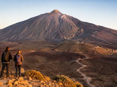 Hikers looking toward Mount Teide in Tenerife's volcanic national park landscape