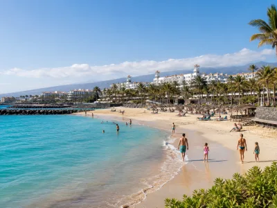 Family-friendly beach in Tenerife with calm water, golden sand and a resort promenade