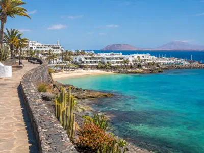 Sunny Playa Blanca resort promenade and sheltered beach in Lanzarote