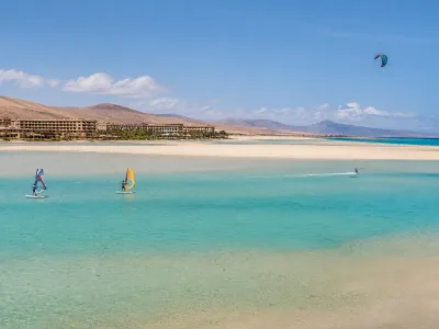 Sotavento Beach lagoon near Costa Calma with windsurfers and beach hotels in Fuerteventura