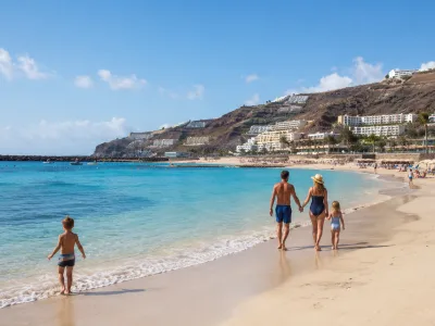 Family beach holiday scene at a calm sheltered bay in southwest Gran Canaria near Puerto Rico and Amadores