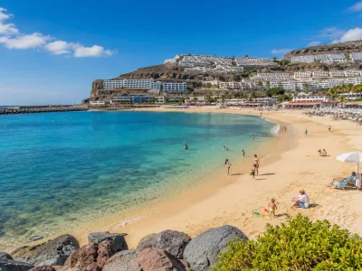 Family-friendly resort beach in southern Gran Canaria with calm water and hotels