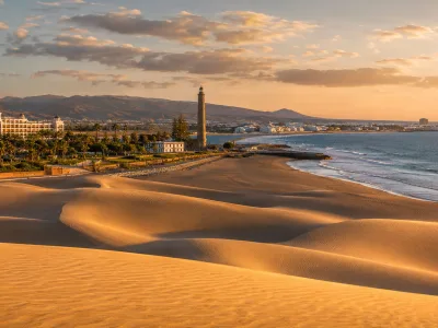 Maspalomas dunes, lighthouse and southern Gran Canaria resort coastline near Meloneras and Playa del Ingles