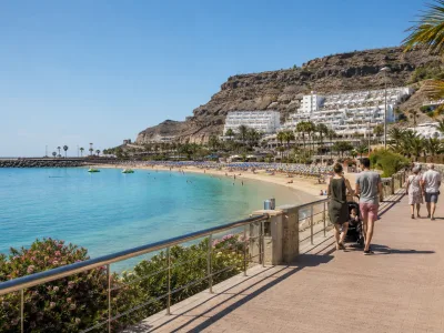 Accessible promenade and calm beach at Playa de Amadores in Gran Canaria for family and mobility-friendly stays