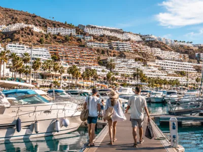 Puerto Rico Marina in Gran Canaria with boats and hillside holiday apartments