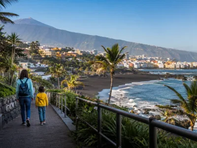 Family walking near Playa Jardin in Puerto de la Cruz, Tenerife, for a Loro Parque holiday