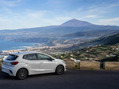 Rental car at a north Tenerife viewpoint above Puerto de la Cruz with Mount Teide in the distance