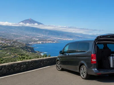 Transfer car on a scenic Tenerife road towards Puerto de la Cruz with the Orotava Valley and north coast in the distance