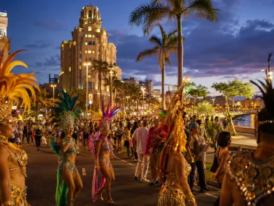 Carnival evening near Plaza de Espana in Santa Cruz de Tenerife with hotels and festive crowds