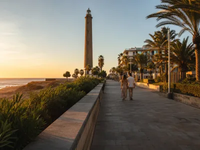 Couple walking near Faro de Maspalomas and the Meloneras promenade in Gran Canaria