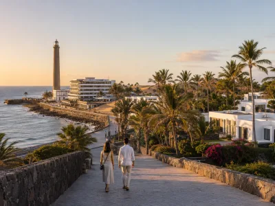Maspalomas Lighthouse, oceanfront hotels and palm oasis at sunset in Gran Canaria