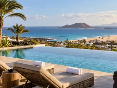 Adults-only resort pool overlooking the Atlantic, Corralejo dunes and Isla de Lobos in Fuerteventura