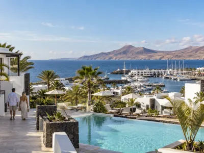 Whitewashed Lanzarote resort with volcanic-stone walls, a pool and Marina Rubicon overlooking the Atlantic