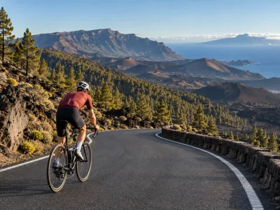 Road cyclist climbing through volcanic Canary Islands scenery above the Atlantic