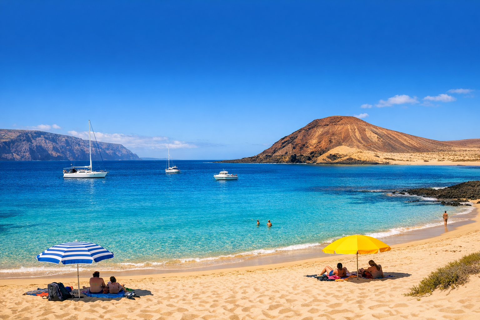 Sunny beach in La Graciosa with turquoise water, pale sand and volcanic hills