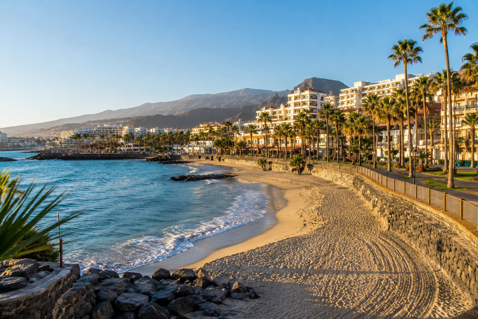 Walkable beach resort area in south Tenerife with hotels, promenade and calm Atlantic water