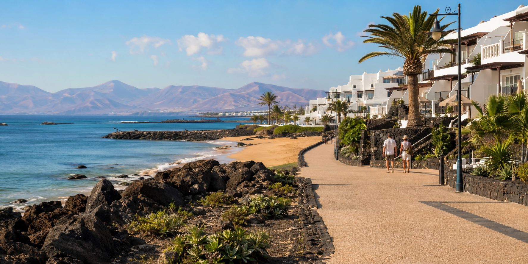 Winter sun resort promenade in Lanzarote with volcanic hills and white coastal architecture
