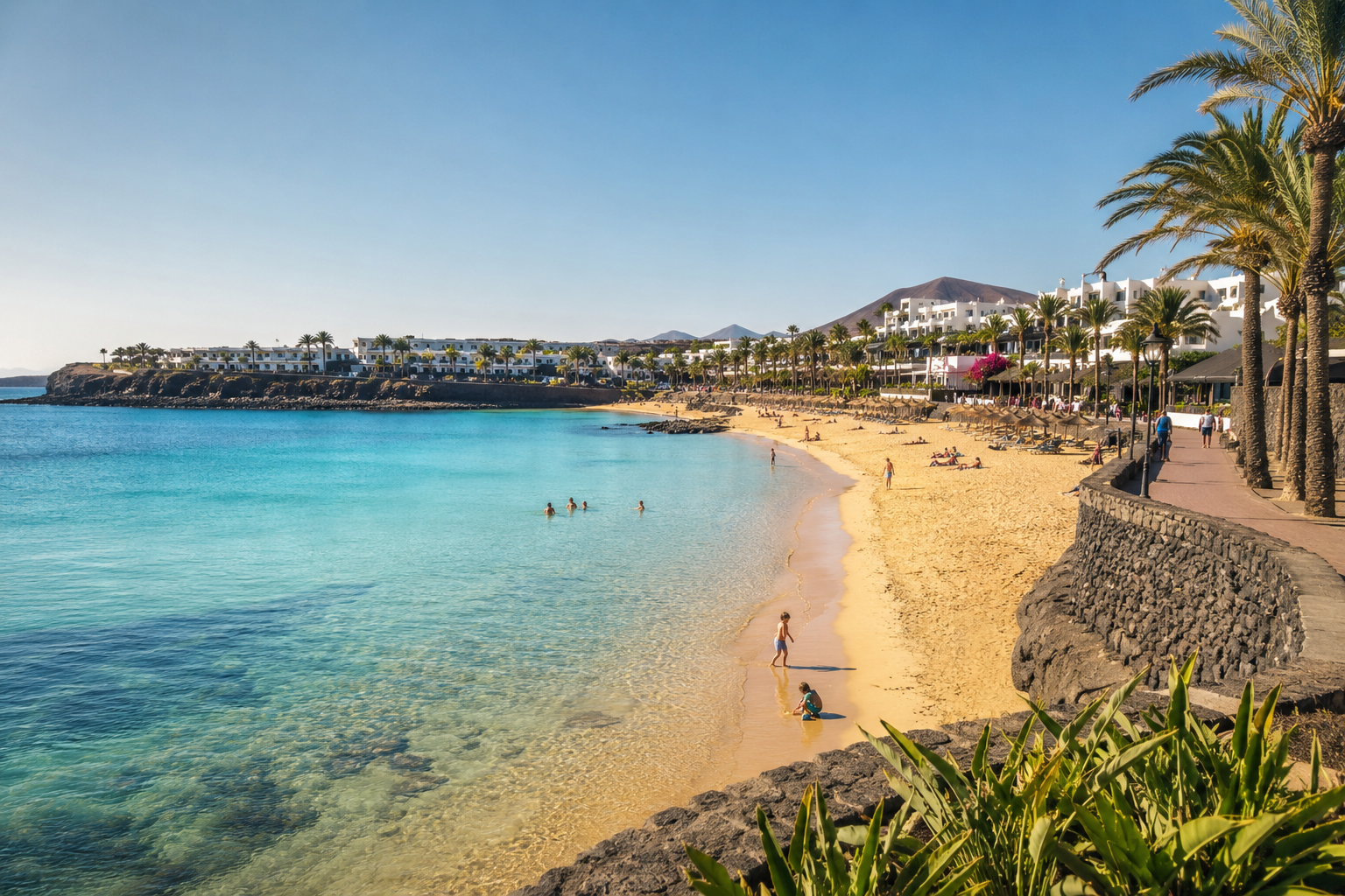 Families enjoying the sheltered Playa Dorada beach near resort hotels in Playa Blanca, Lanzarote