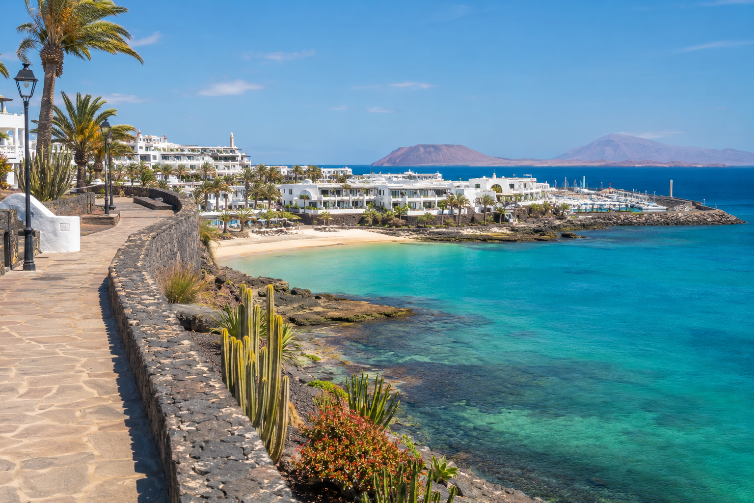 Sunny Playa Blanca resort promenade and sheltered beach in Lanzarote