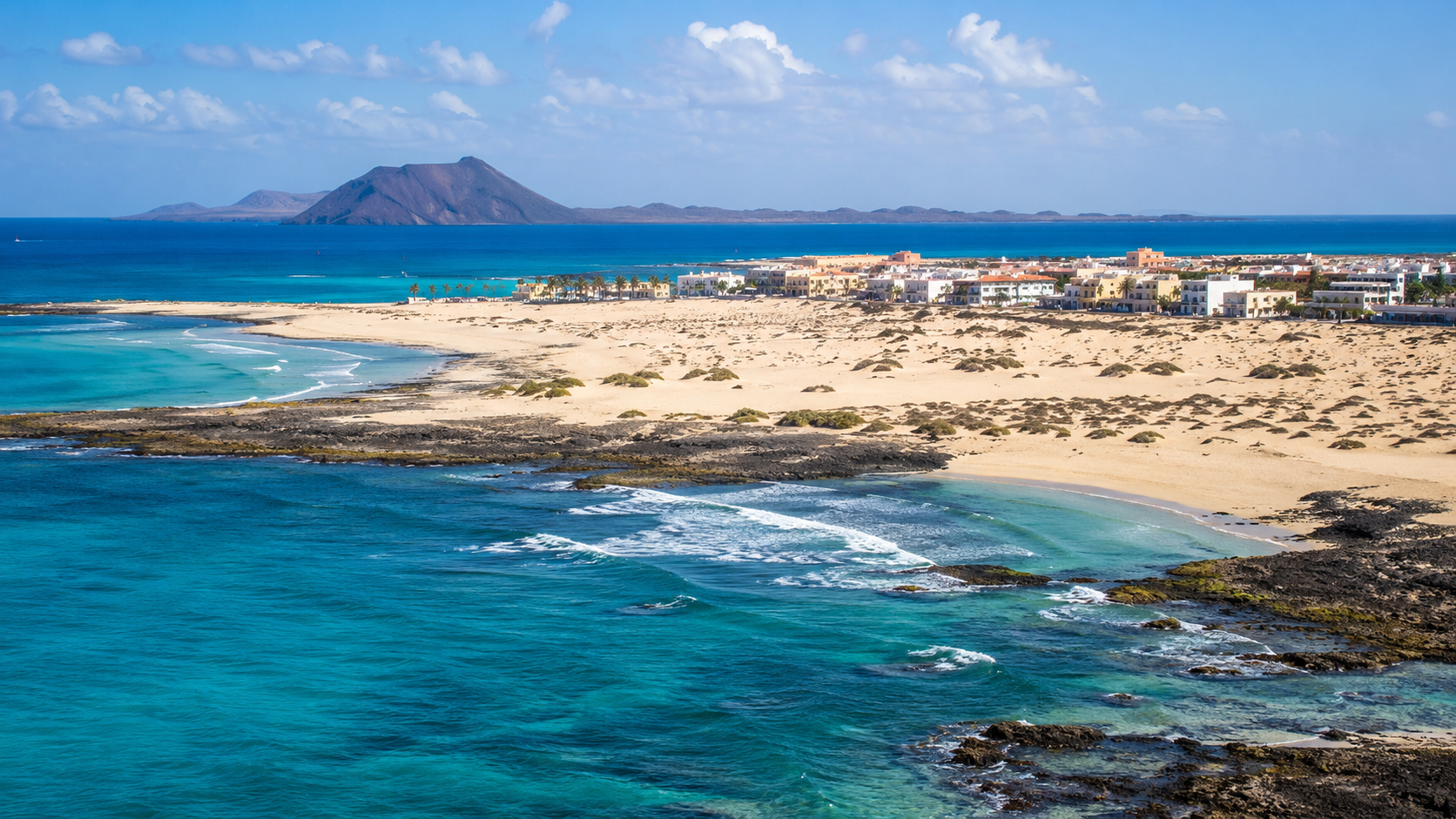 Corralejo dunes, turquoise sea and resort coastline in northern Fuerteventura