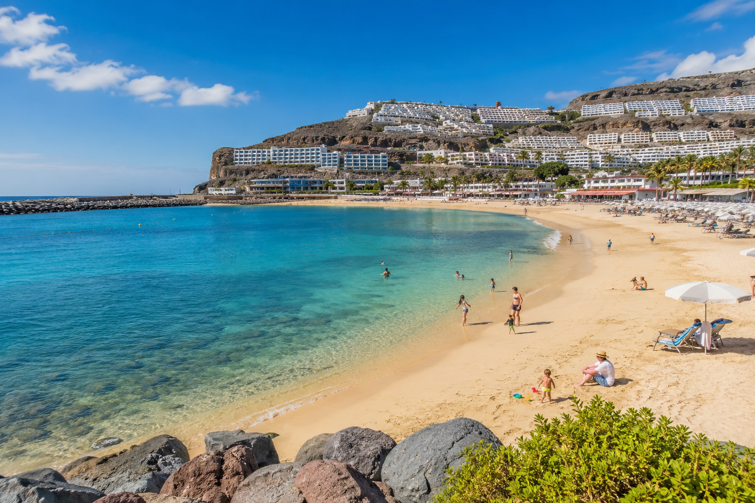Family-friendly resort beach in southern Gran Canaria with calm water and hotels