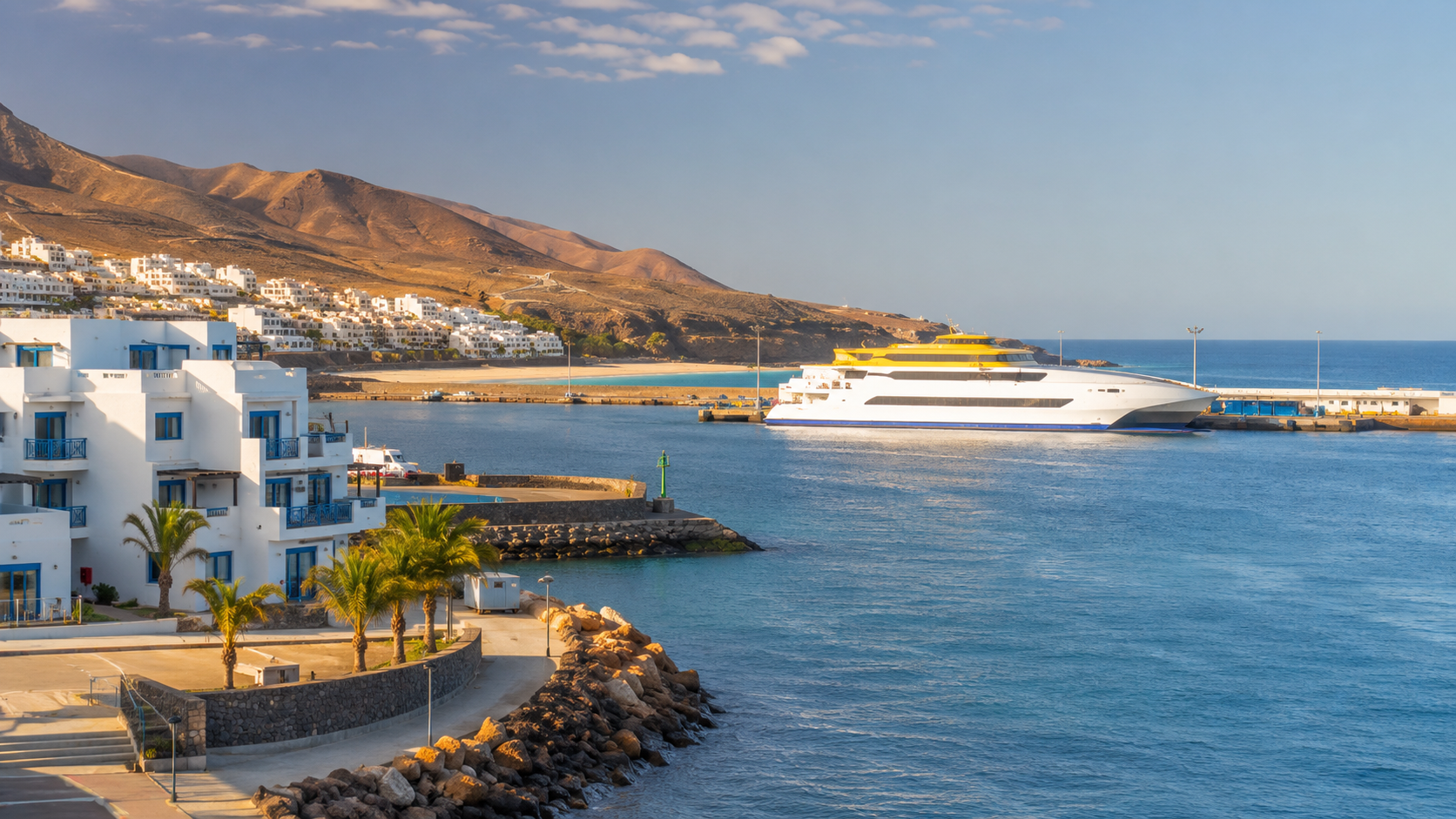 Morro Jable ferry port and coastal hotels in Fuerteventura for travellers crossing to Gran Canaria