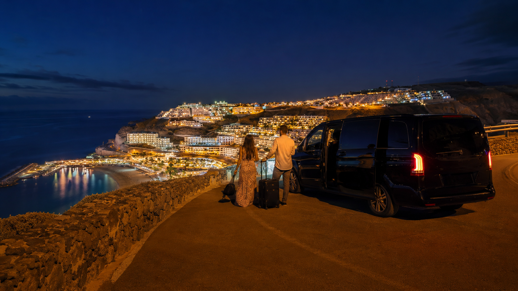 Private transfer at night above the lit Puerto Rico and Amadores coastline in Gran Canaria