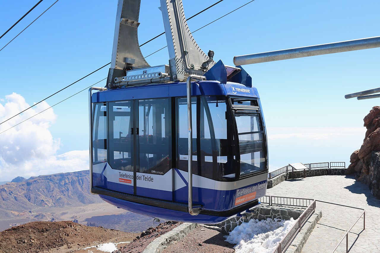 Blue Teide cable car carriage travelling above the national park volcanic slopes